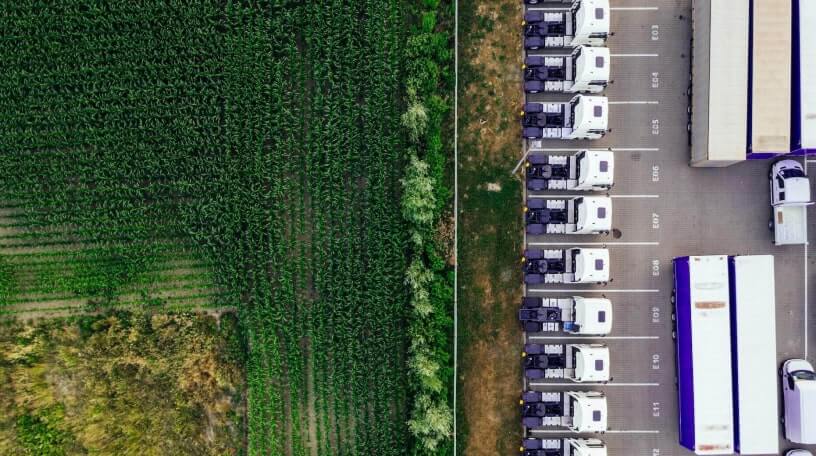 Trucks parked next to field