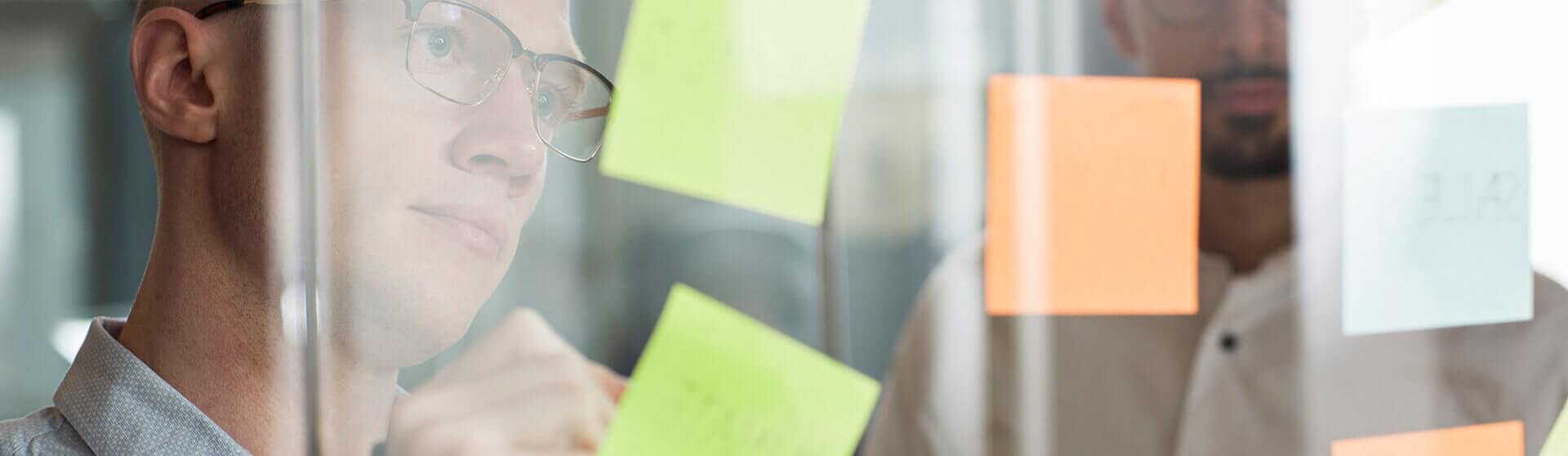 Person writing on post-its