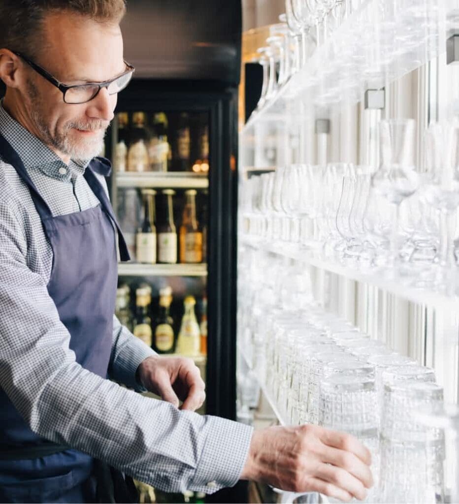 Waiter arranging glasses